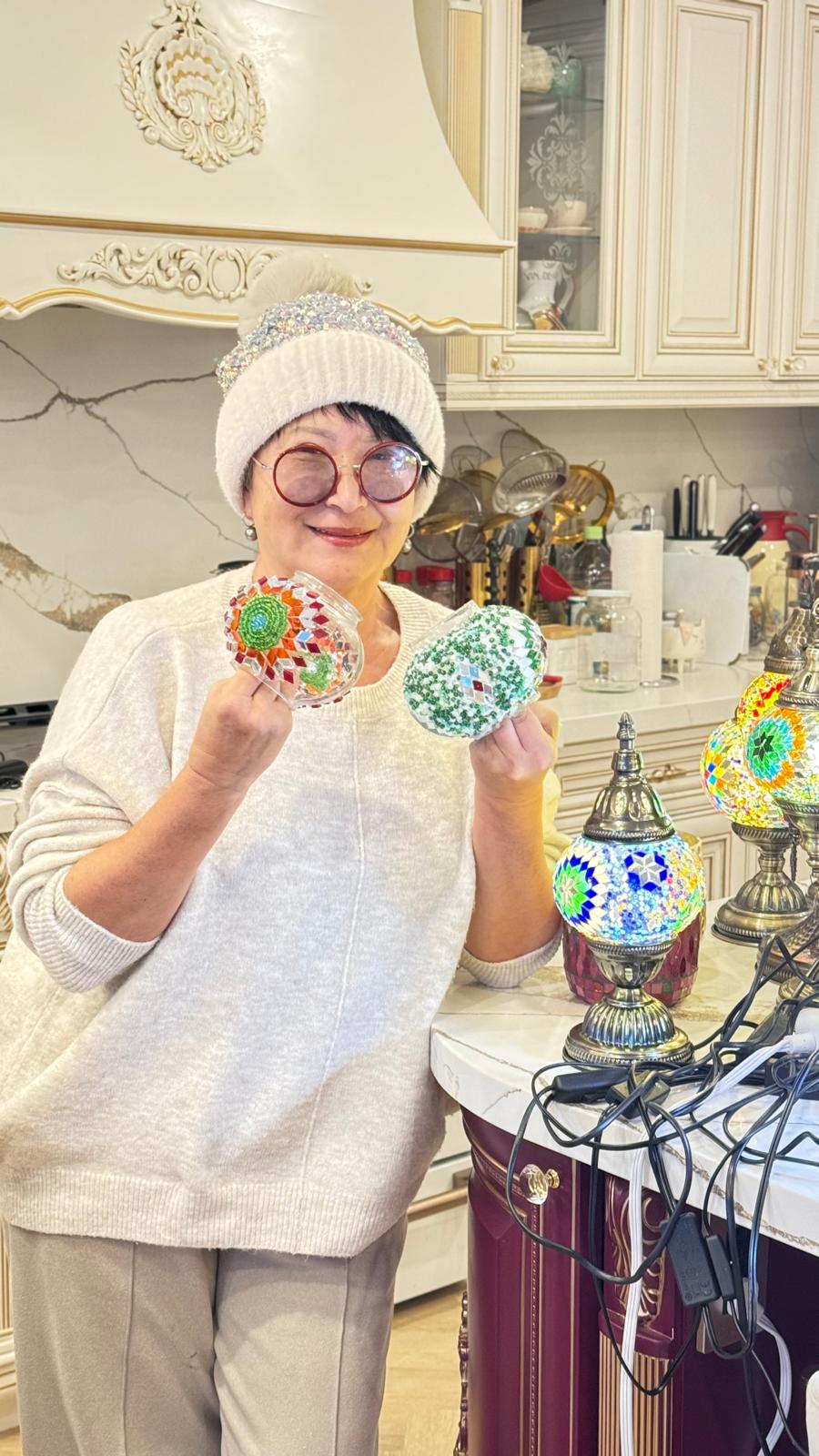 Nadia holding handcrafted mosaic lamp globes